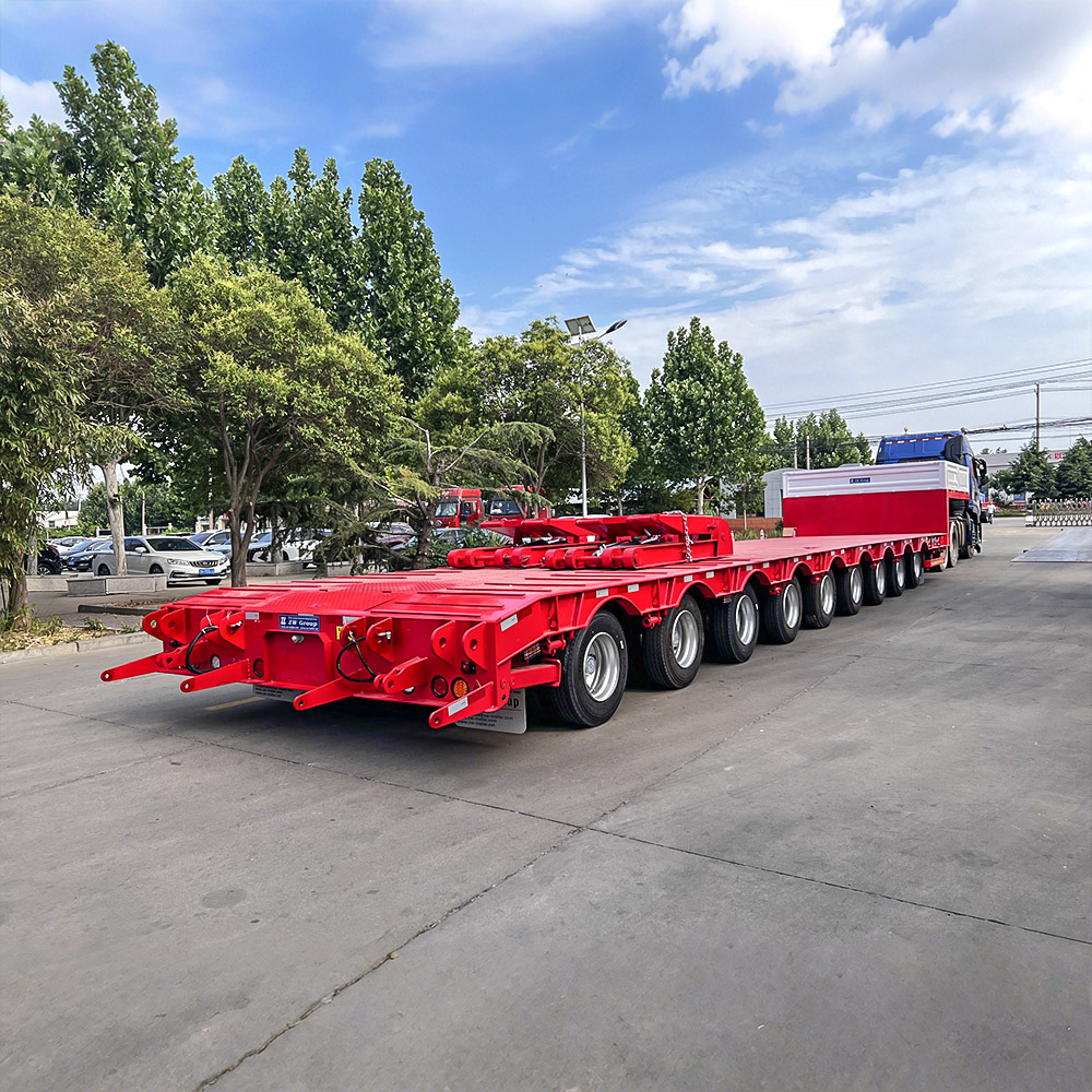 Red 9 axle heavy-duty lowbed trailer for oversized and heavy machinery transpor