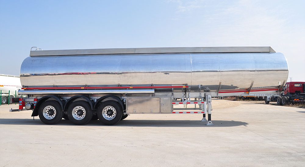 ZW 3 axle polished aluminum tanker trailer with high-capacity tank and lightweight alloy build for fuel and oil transport.