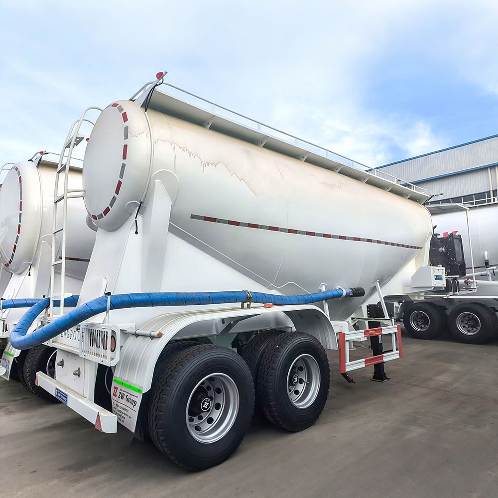 V-shaped cement powder trailer showing discharge valve and dual manholes