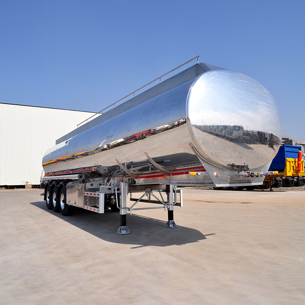 ZW 3 axle polished aluminum tanker trailer with high-capacity tank and lightweight alloy build for fuel and oil transport.