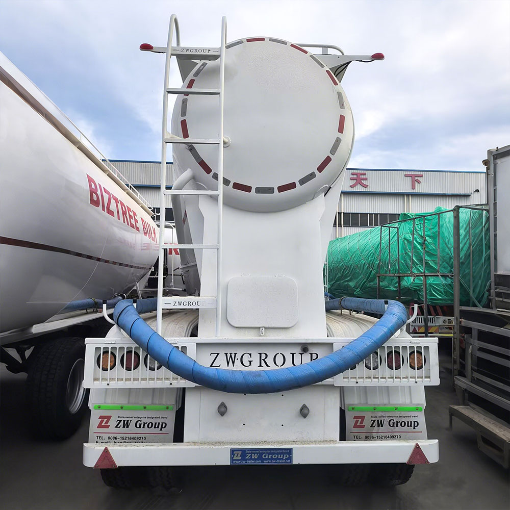 V-shaped cement powder trailer showing discharge valve and dual manholes