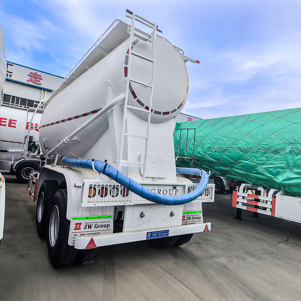 V-shaped cement powder trailer showing discharge valve and dual manholes