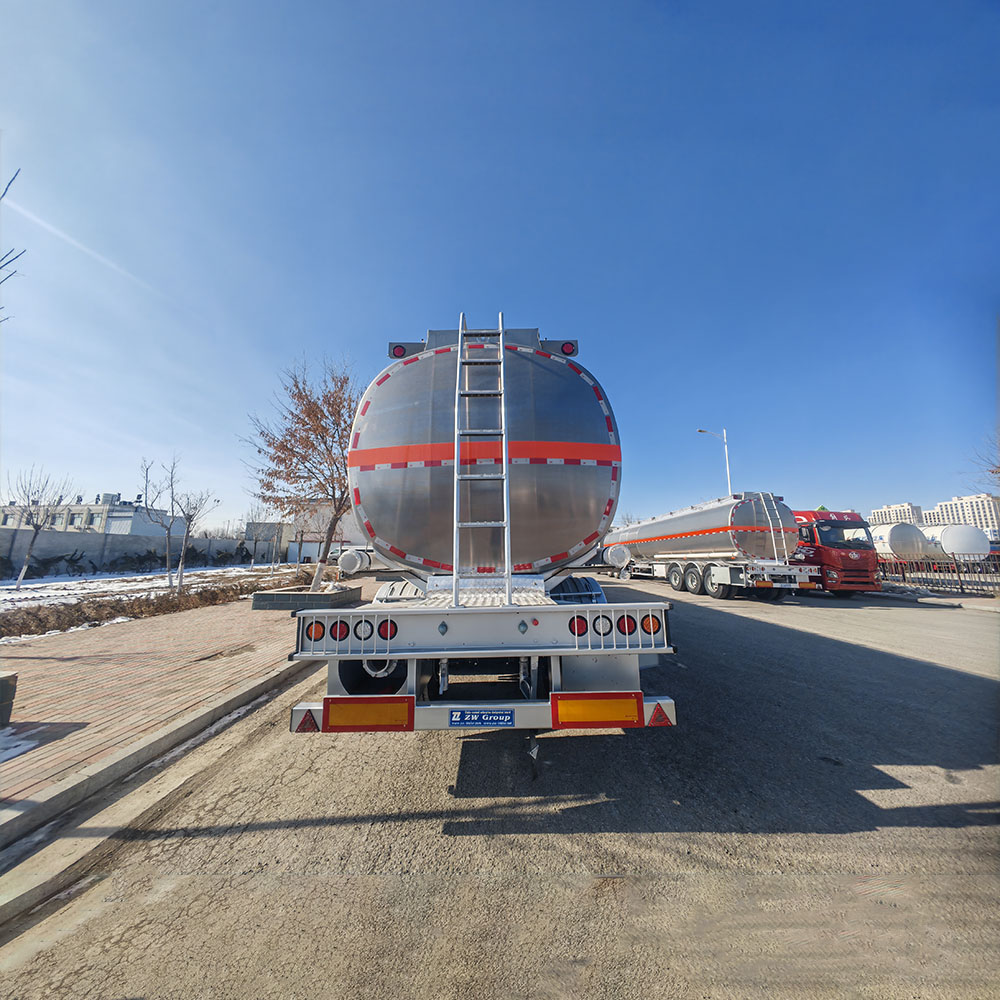 ZW fuel tanker trailer with 55-ton payload, featuring raw aluminum body and orange stripe accents for modern fleet operations.
