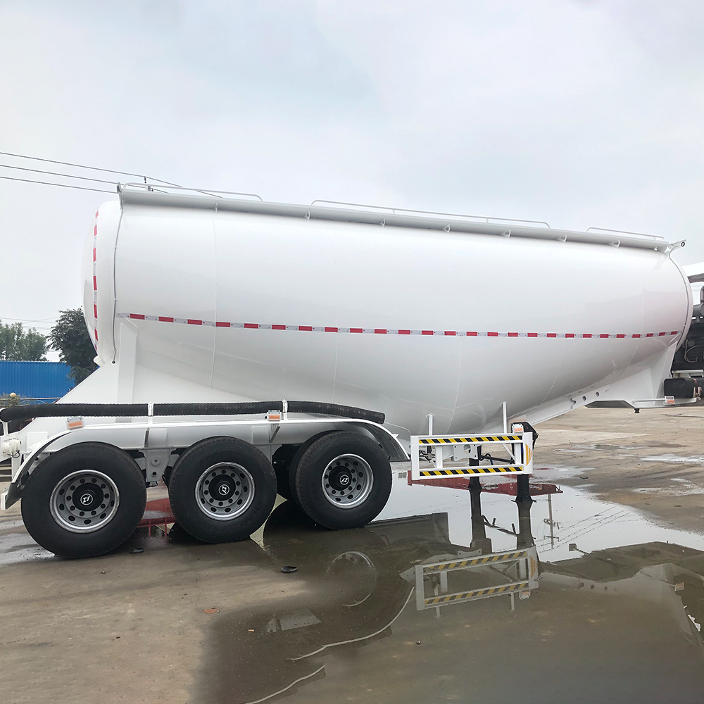 Bulk cement transport trailer showing V-type tank and rear discharge piping