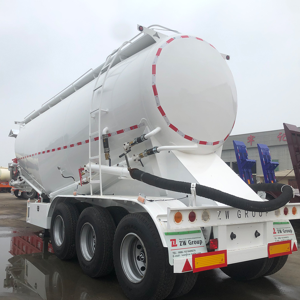 Bulk cement transport trailer showing V-type tank and rear discharge piping