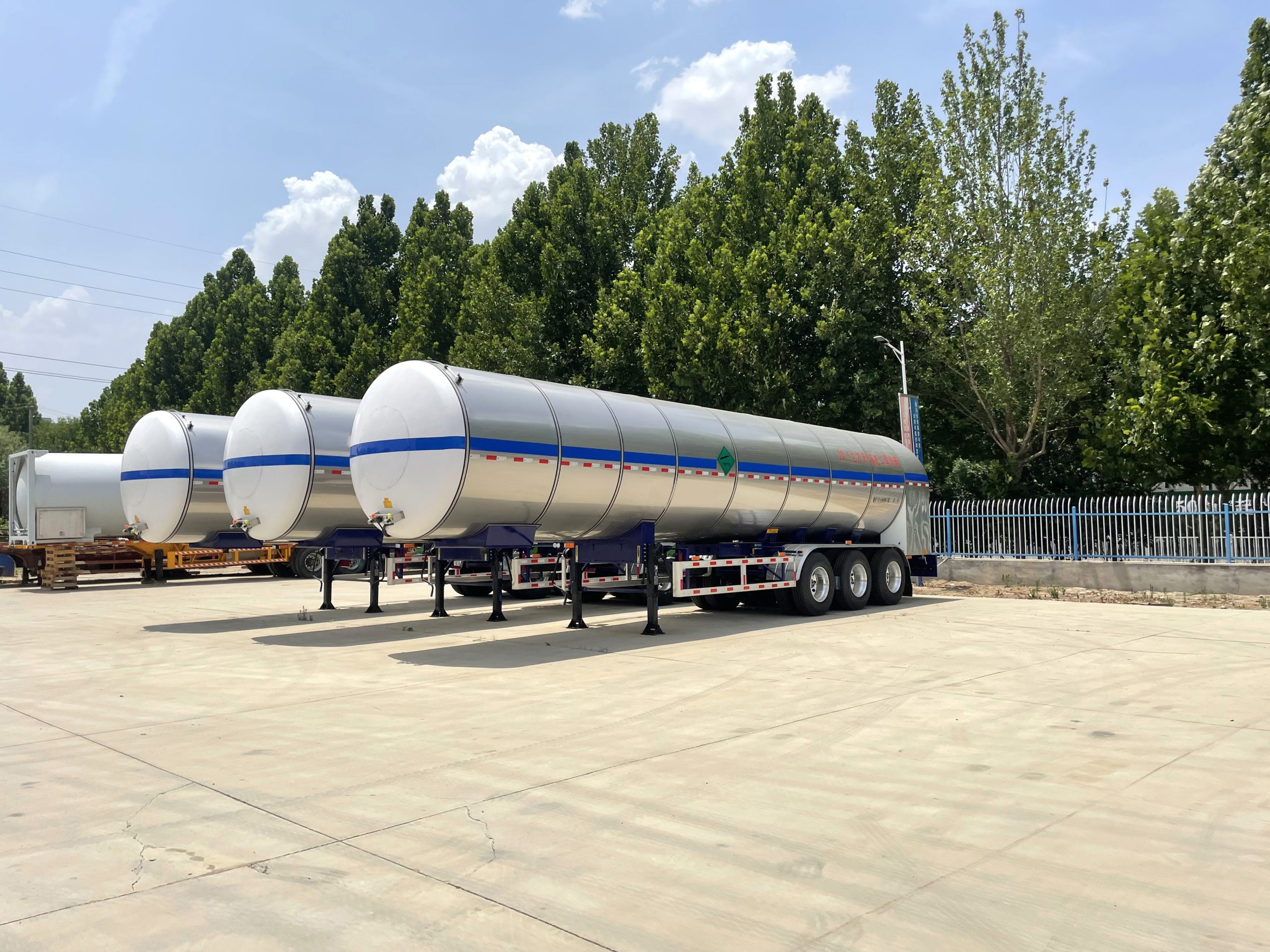 Triple-axle chemical trailer showing stainless steel tank and BPW axles