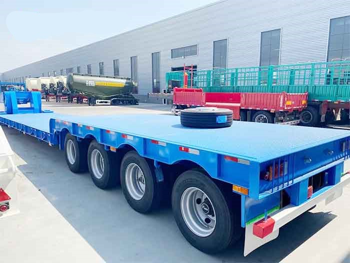 Blue heavy-duty 4 axle RGN trailer for transporting large equipment